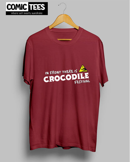 In Front there is a Crocodile Festival T-Shirt