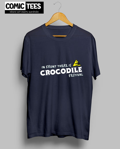 In Front there is a Crocodile Festival T-Shirt