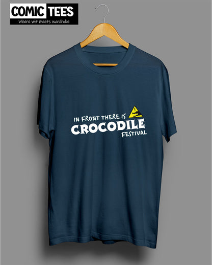 In Front there is a Crocodile Festival T-Shirt